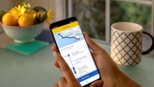 Woman plugging in electric vehicle at a charging station